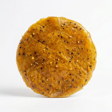 Kaihunnyam Chakka Pappad (Jackfruit) Pappads, 10 pieces, crispy Indian snack on a white plate with green leaves.