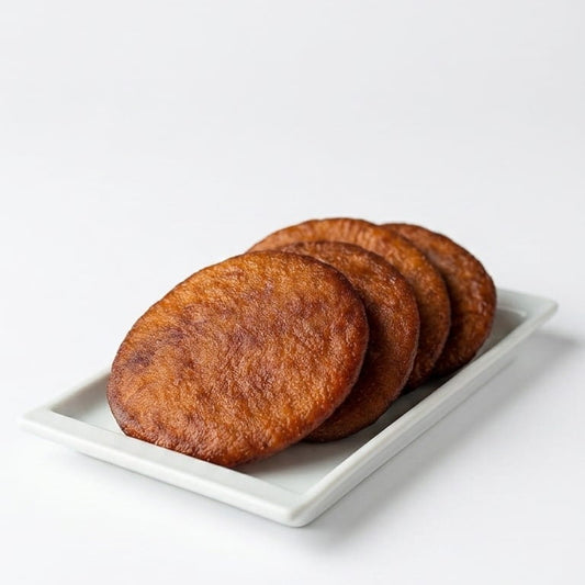 Plate of five traditional Kaipunnyam Athirasam snacks, golden-brown and crispy, on a white background.